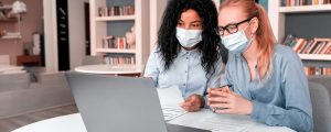 Two care home workers participating in elearning as part of CQC mandatory training requirements